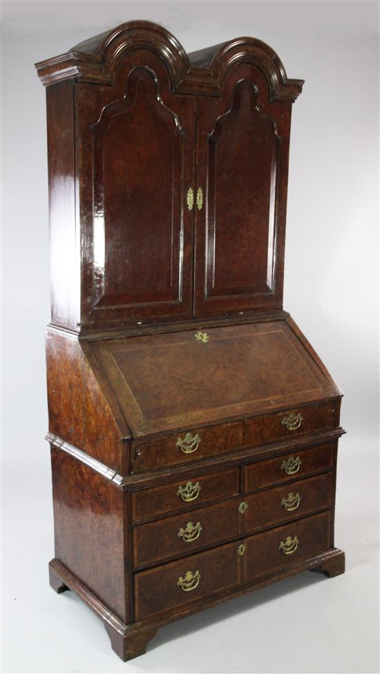 A Queen Anne walnut and featherbanded bureau cabinet, W.3ft 5in.